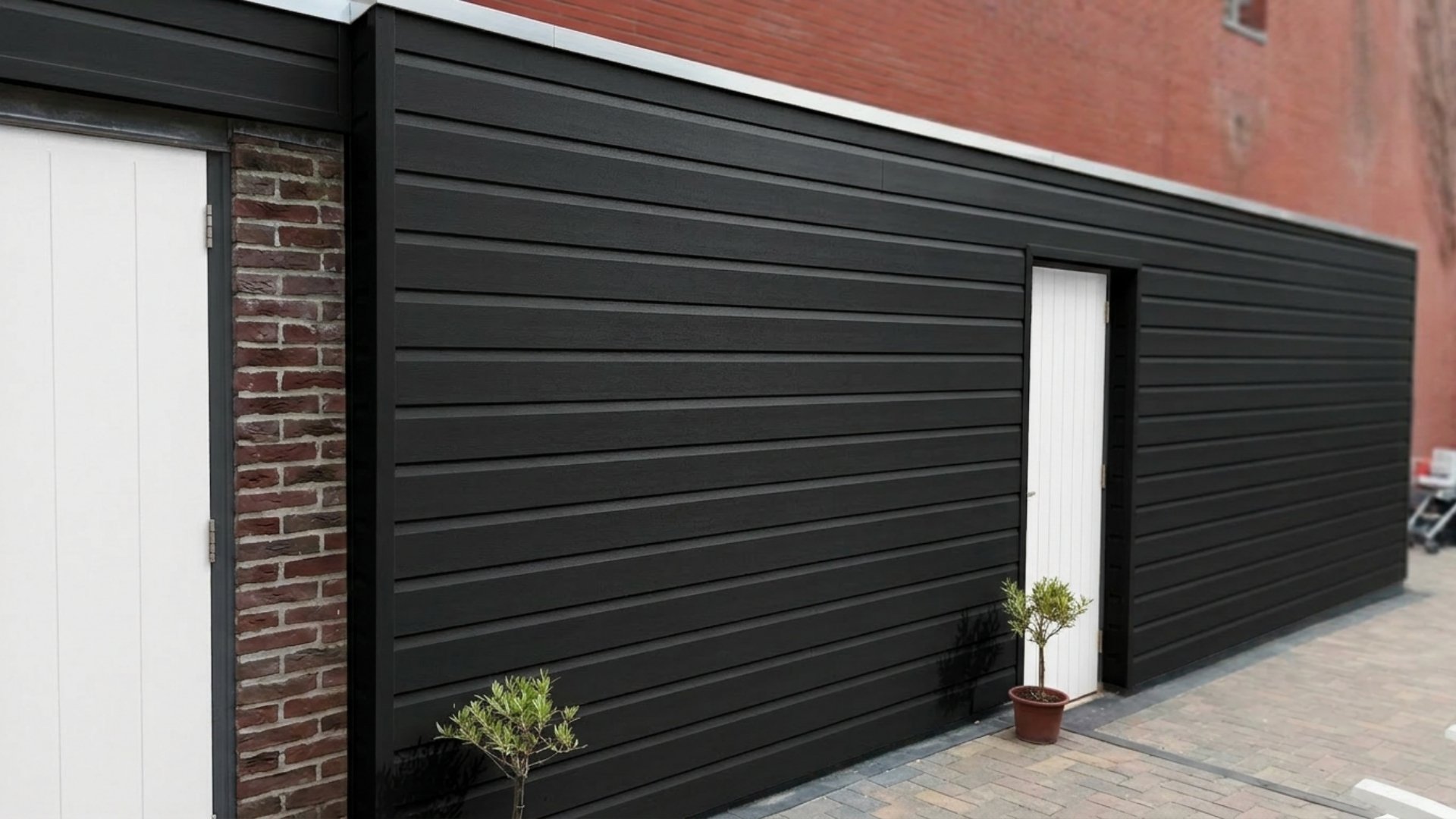 VinyPlus rondkant zwart toegepast als kunststof gevelbekleding met strakke afwerking en witte deur